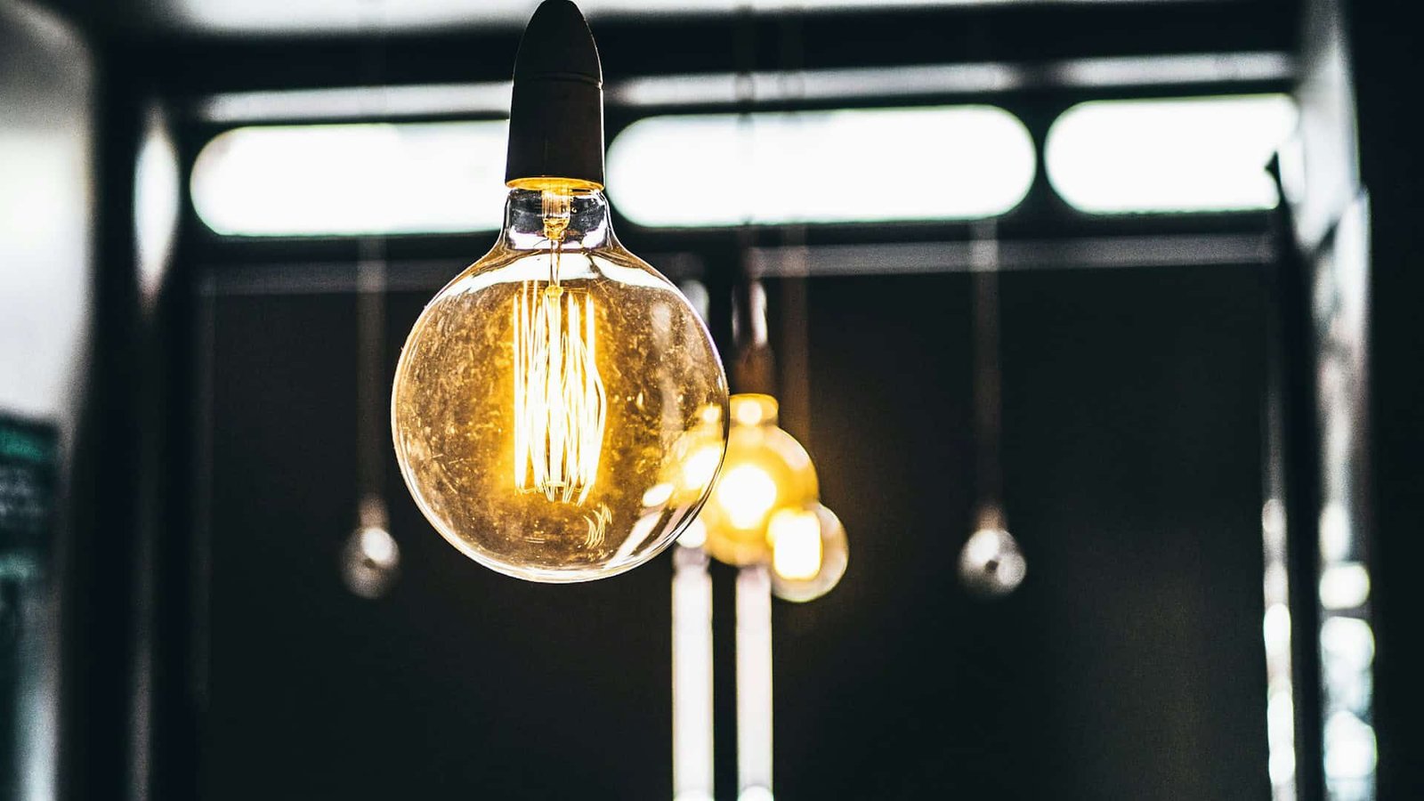 Lit light bulbs hanging from the ceiling