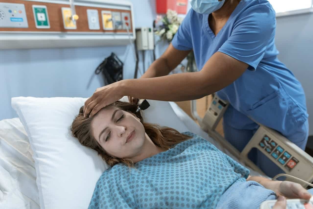 Sick woman lying in a hospital bed