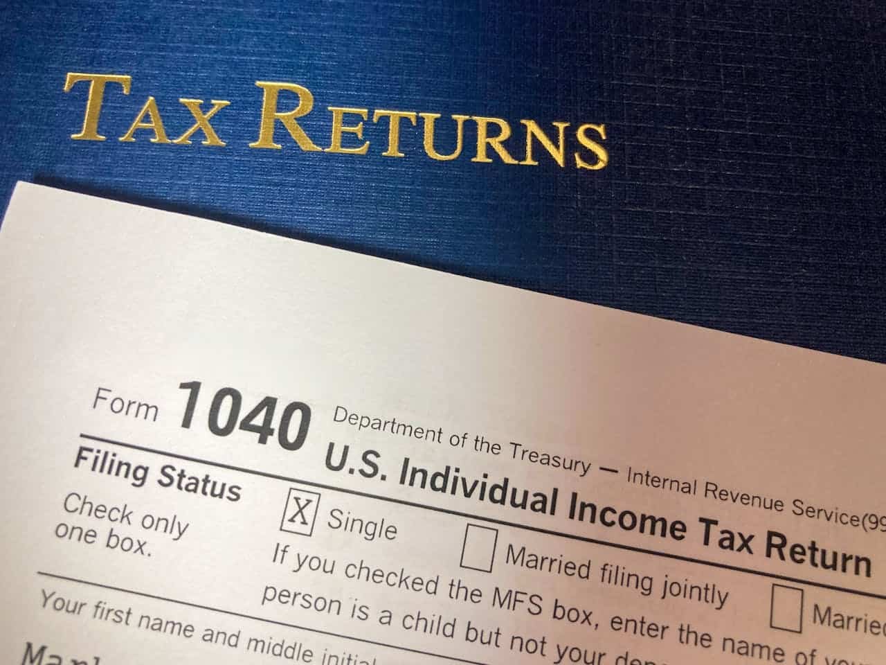 US 1040 form on top of tax returns folder