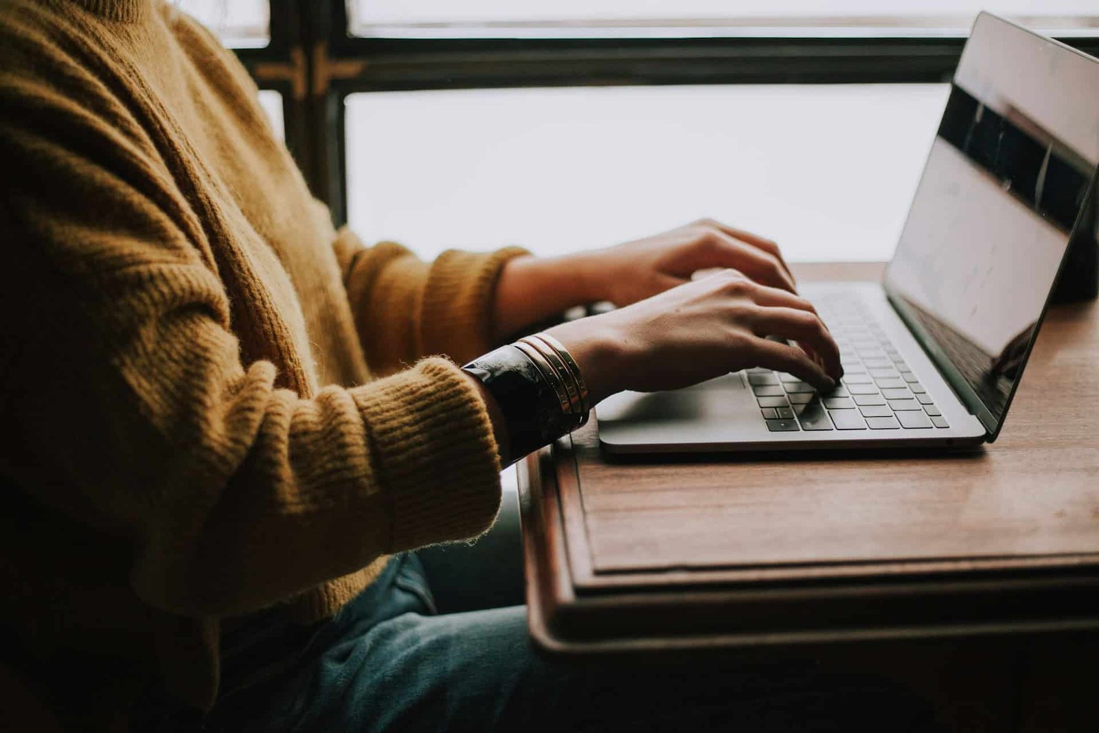 Person sitting in front of a laptop