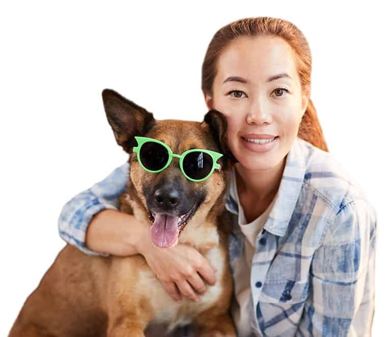 Woman hugging dog wearing sunglasses.