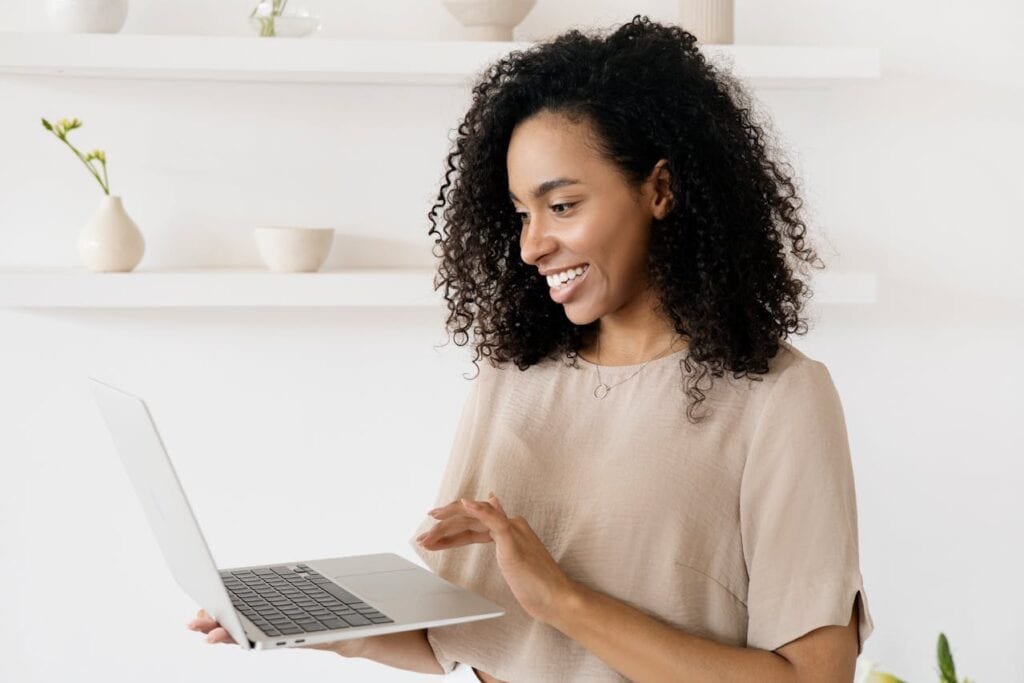 Happy woman using laptop computer