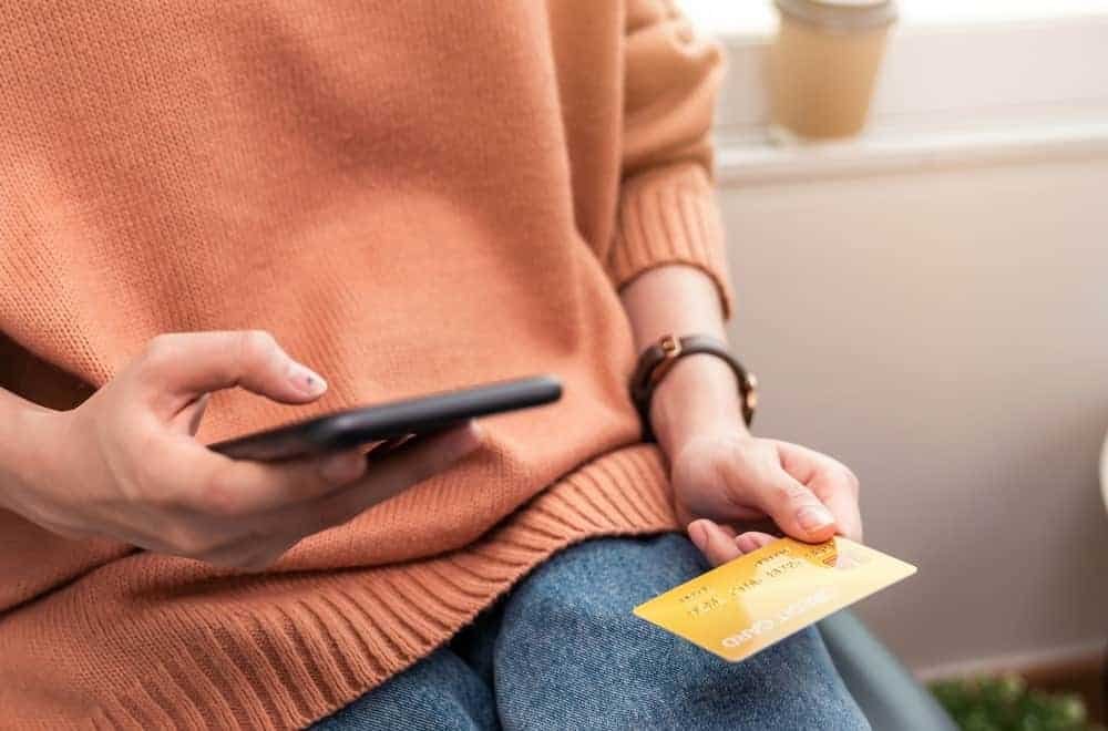 Lady entering credit card information in her smartphone