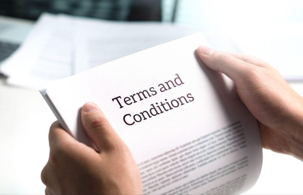 Person holding text reading ‘terms and conditions’