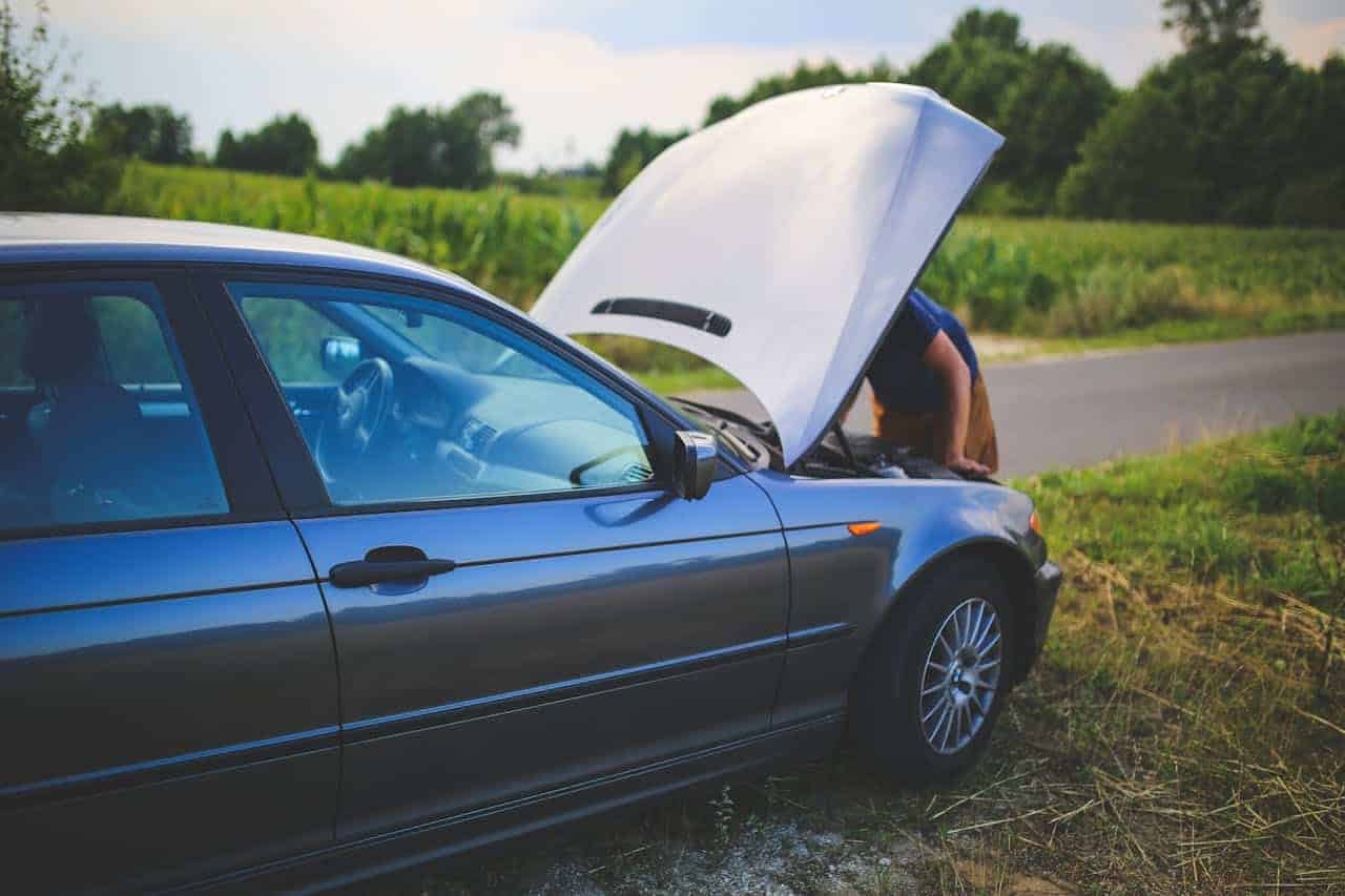 Car on roadside with open engine compartment