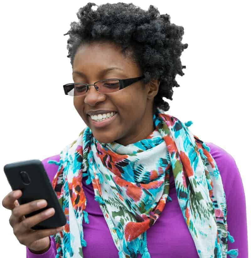 A smiling woman looking at her online installment loan approval on her phone.